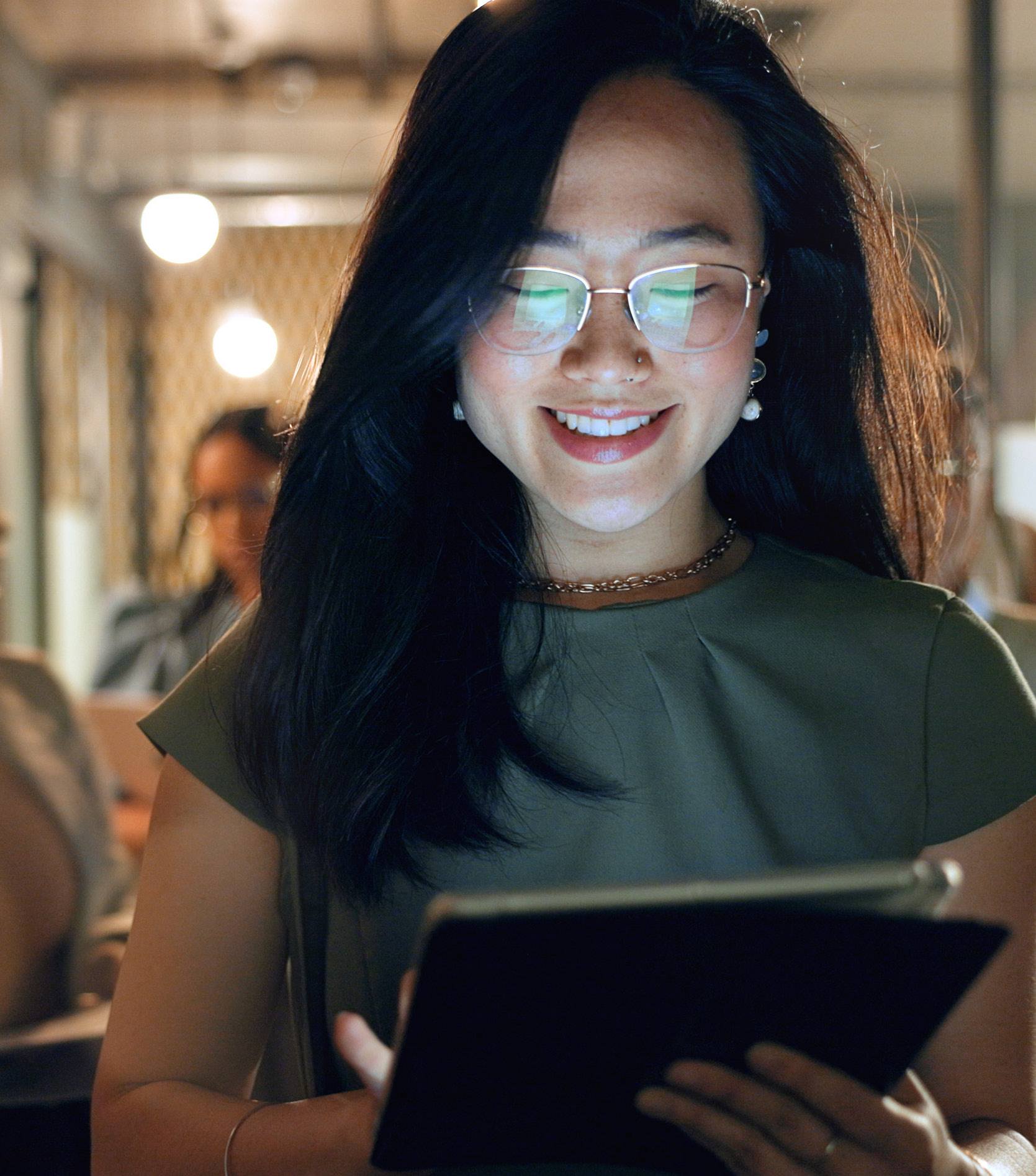Leader reading on a tablet, screen glow